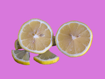Close-up of lemon slice against pink background