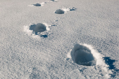 High angle view of footprints on sand at beach