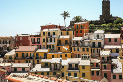 Scenic view of town next to sea against clear sky