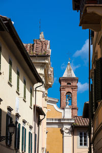 Low angle view of buildings against blue sky