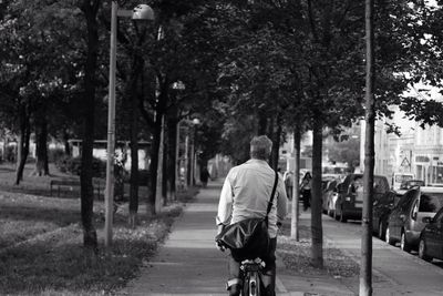 Rear view of woman walking on footpath