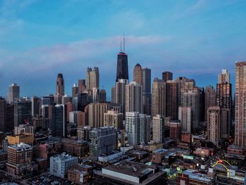 Aerial view of modern buildings in city against sky