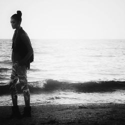 Rear view of woman standing on beach