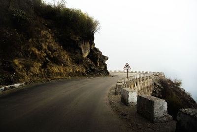 Road by mountain against clear sky