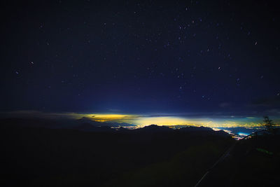 Scenic view of illuminated mountain against sky at night