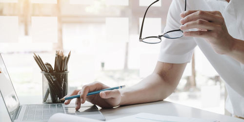 Midsection of woman working on table