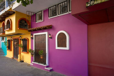 Multi colored houses on wall of building