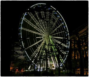 Low angle view of illuminated ferris wheel