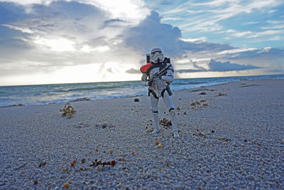 Rear view of man with surfboard on beach