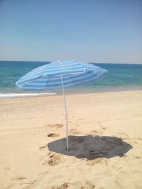 Scenic view of beach against blue sky