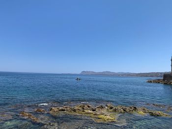 Scenic view of sea against clear blue sky