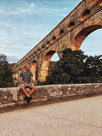 Low angle view of arch bridge against sky