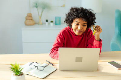 Young woman using laptop on table