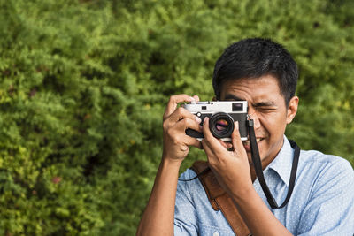 Man taking a picture with a classic range finder camera