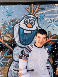 Portrait of smiling man holding camera