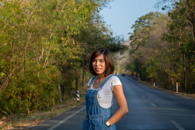 Portrait of woman standing on road 