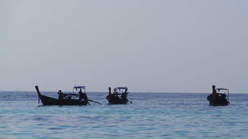 Silhouette boats sailing on sea