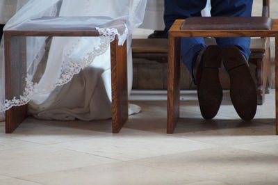 Low section of woman sitting on chair