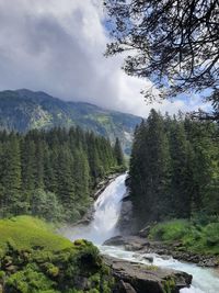 Scenic view of waterfall against sky