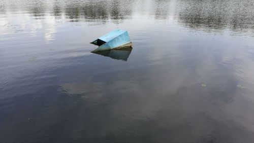 High angle view of abandoned boat floating on lake