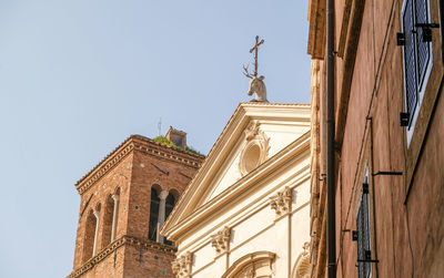 Low angle view of statues on building against sky