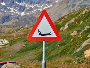 Road sign against mountain