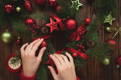 Midsection of woman with christmas tree