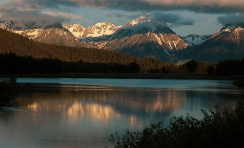 Scenic view of lake and mountains against sky during winter