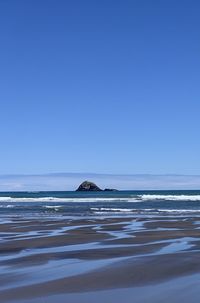 Scenic view of sea against clear blue sky