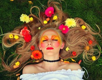 Portrait of young woman with multi colored flowers