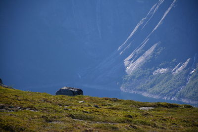 Scenic view of mountains against blue sky