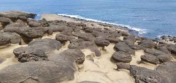 High angle view of rocks on beach against sky