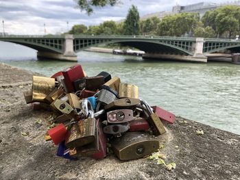 Padlocks on bridge over river