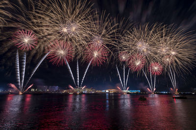 Low angle view of firework display at night