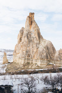 Scenic view of rock formation against sky during winter