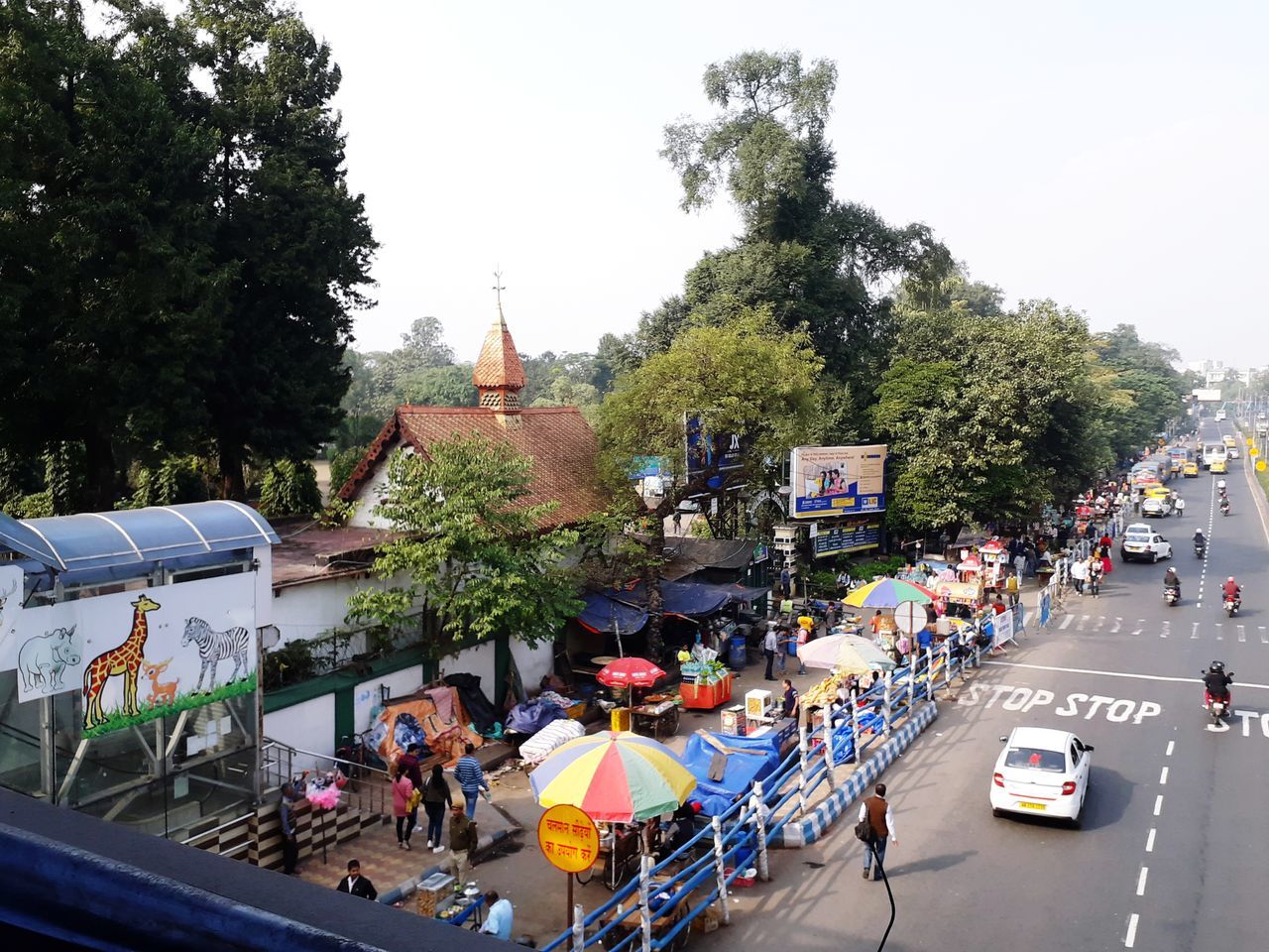 HIGH ANGLE VIEW OF PEOPLE ON ROAD