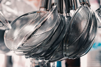 Close-up of kitchen utensils hanging in store for sale