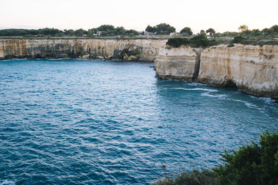 Scenic view of rocky shore and sea 