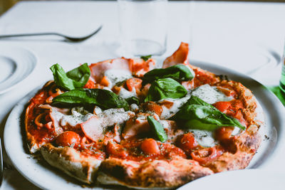 Close-up of pizza in plate on table