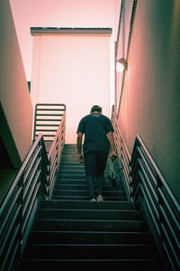 Rear view of woman walking on stairs