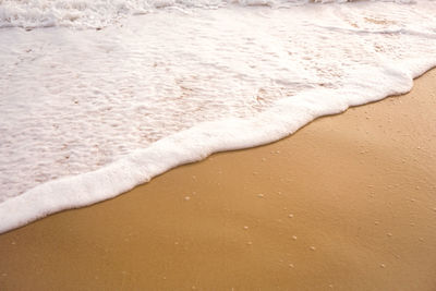 High angle view of waves rushing towards shore