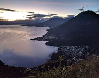 Scenic view of lake against sky at sunset