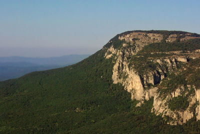 A landscape with foggy mountains silhouettes at morning sunrise. crimean peninsula, sidam qaya