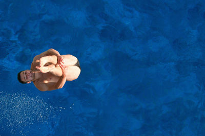 Directly above shot of man jumping in swimming pool