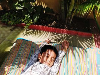 High angle view of boy sleeping on blanket