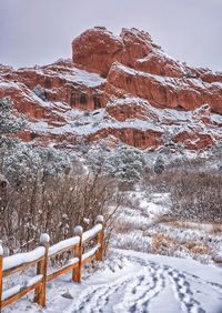 Snow covered land and mountain against sky