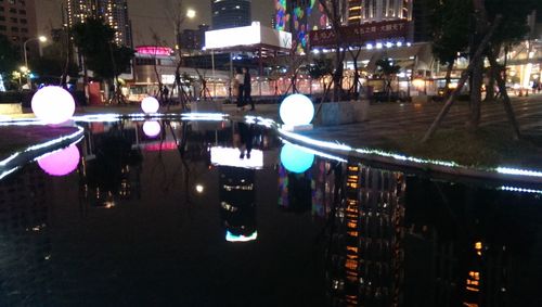 Cars on illuminated city at night