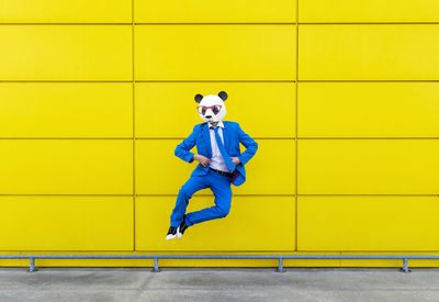 Portrait of man against yellow wall