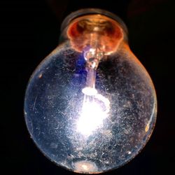 Close-up of lit candle in dark room