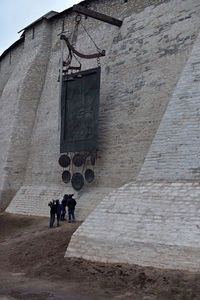 Low angle view of people walking on building